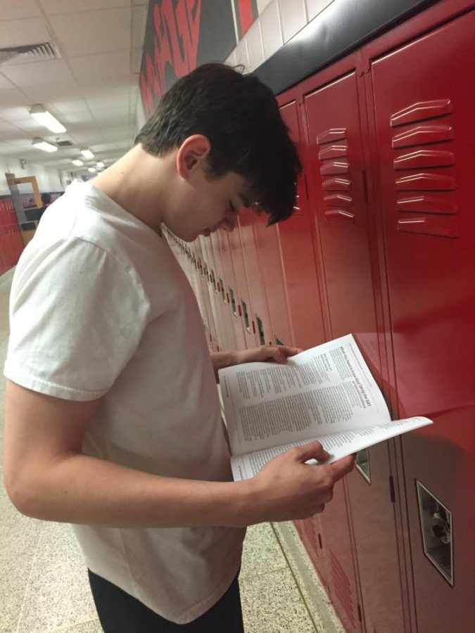 WHS Senior Thomas Evan reads an SAT prep booklet. He last took the SAT in March of 2017.