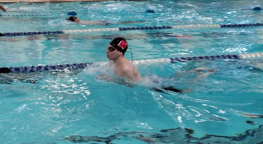 Nestor Matos (junior) is swimming breaststroke whilst warming up for a meet. The swim team versed Metuchen in one of their last meets of the season.