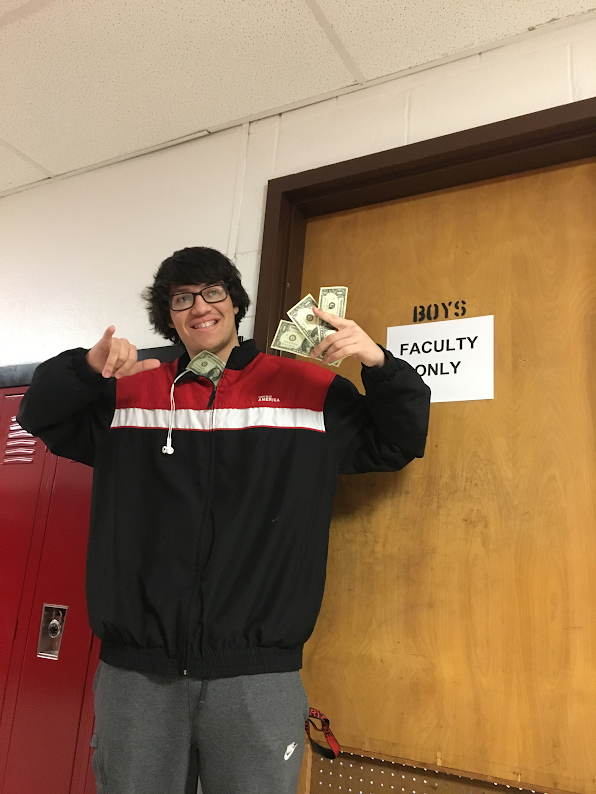 SoundCloud rapper Xhef (Andrew Rodriguez) poses by the D Wing boys bathroom, where the competition will take place. He held $4, his revenue from SoundCloud rapping.