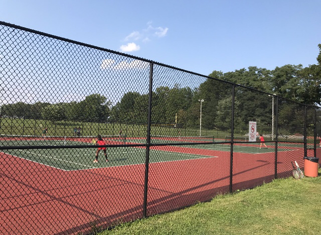 The Woodbridge Tennis Team practices on their court for the first time. The Tennis Program was added at the beginning of this year.