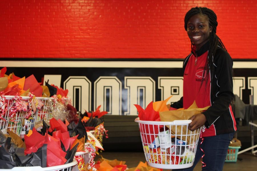 Woodbridge senior Comfort Akuamoah-Boateng helps move Thanksgiving baskets for distribution to families in need on Tuesday, November 21, 2018. Woodbridge High School’s Interact Club prepared 66 baskets for donation through the We Feed Woodbridge organization.