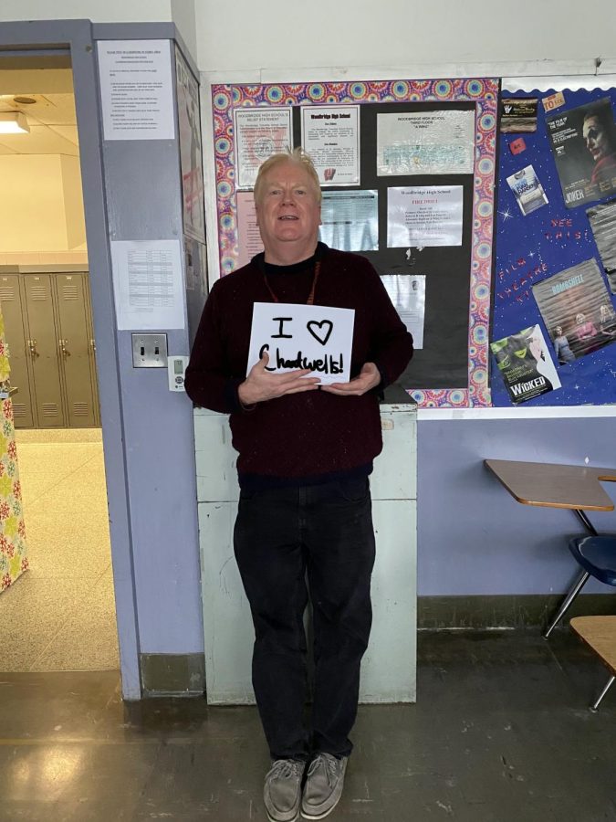 English teacher at Woodbridge High School (WHS), Mr. Lynch, holds a sign that says, I love Chartwells! Mr. Lynch was excited for the return of Chartwells. 