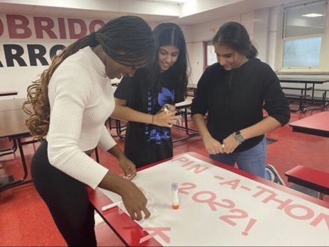National Honor Society students making signs to advertise for Woodbridge High School-Pinkathon.