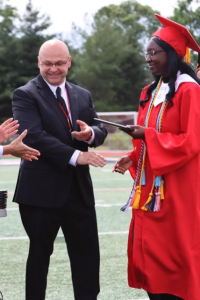 Mr. Osborne hands out diplomas at last year's graduation ceremony.