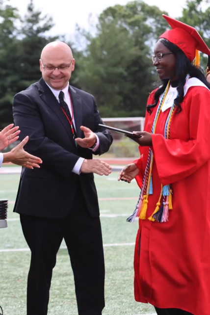 Mr. Osborne hands out diplomas at last years graduation ceremony.