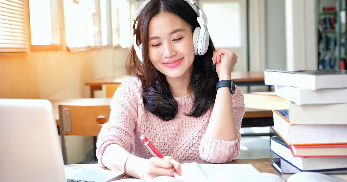 This photo was taken by Vaughn College, showing a student listening to music while working.