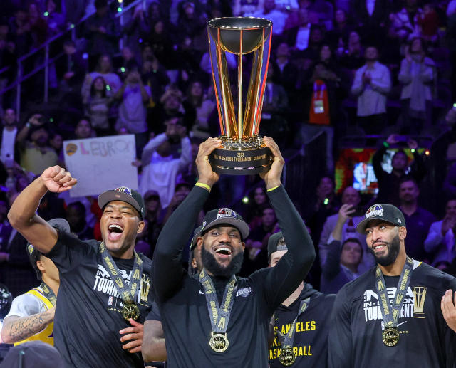 Lebron James holds trophy after in-season tournament victory.
