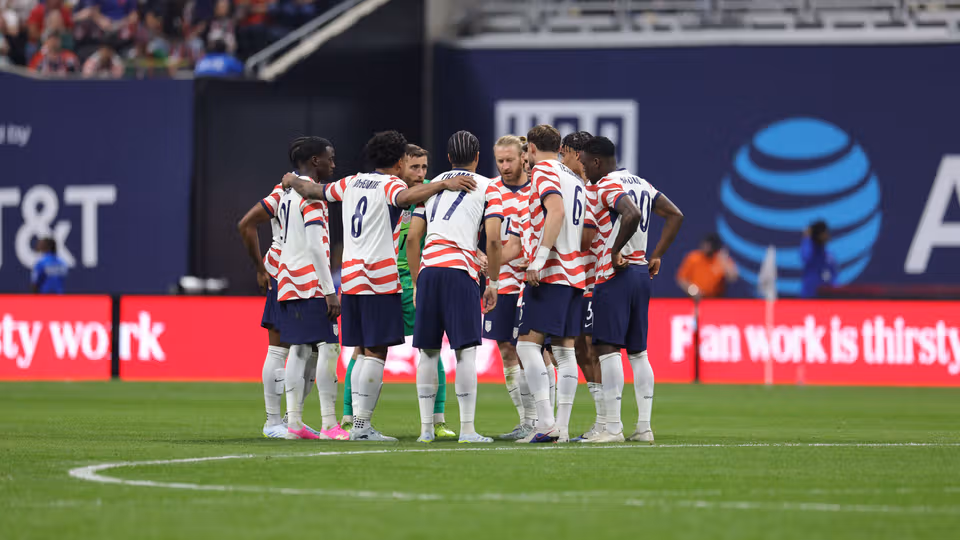The men's team huddles during a game

Photo Credit: US Soccer